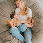 A young mother cuddlinng her son on a premium XL dunes bean bag
