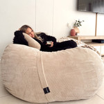 A beautiful lady on a premium XL camel bean bag